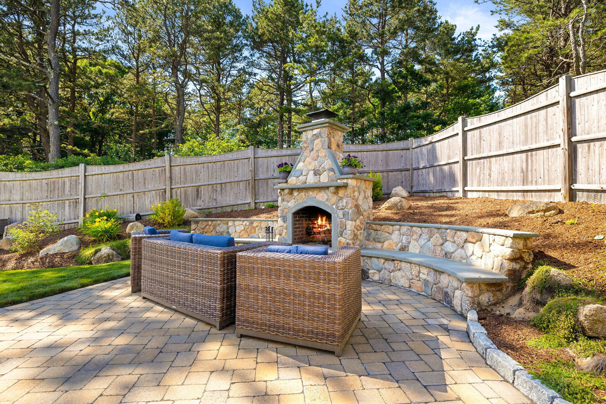 48 Meadowbrook Road Mashpee, MA 02649 - Photo 41 of 52 a view of a backyard with couches plants and wooden fence