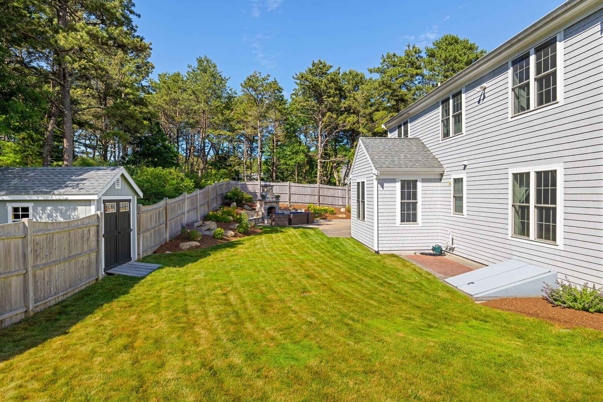 48 Meadowbrook Road Mashpee, MA 02649 - Photo 46 of 52 a view of a backyard with a patio