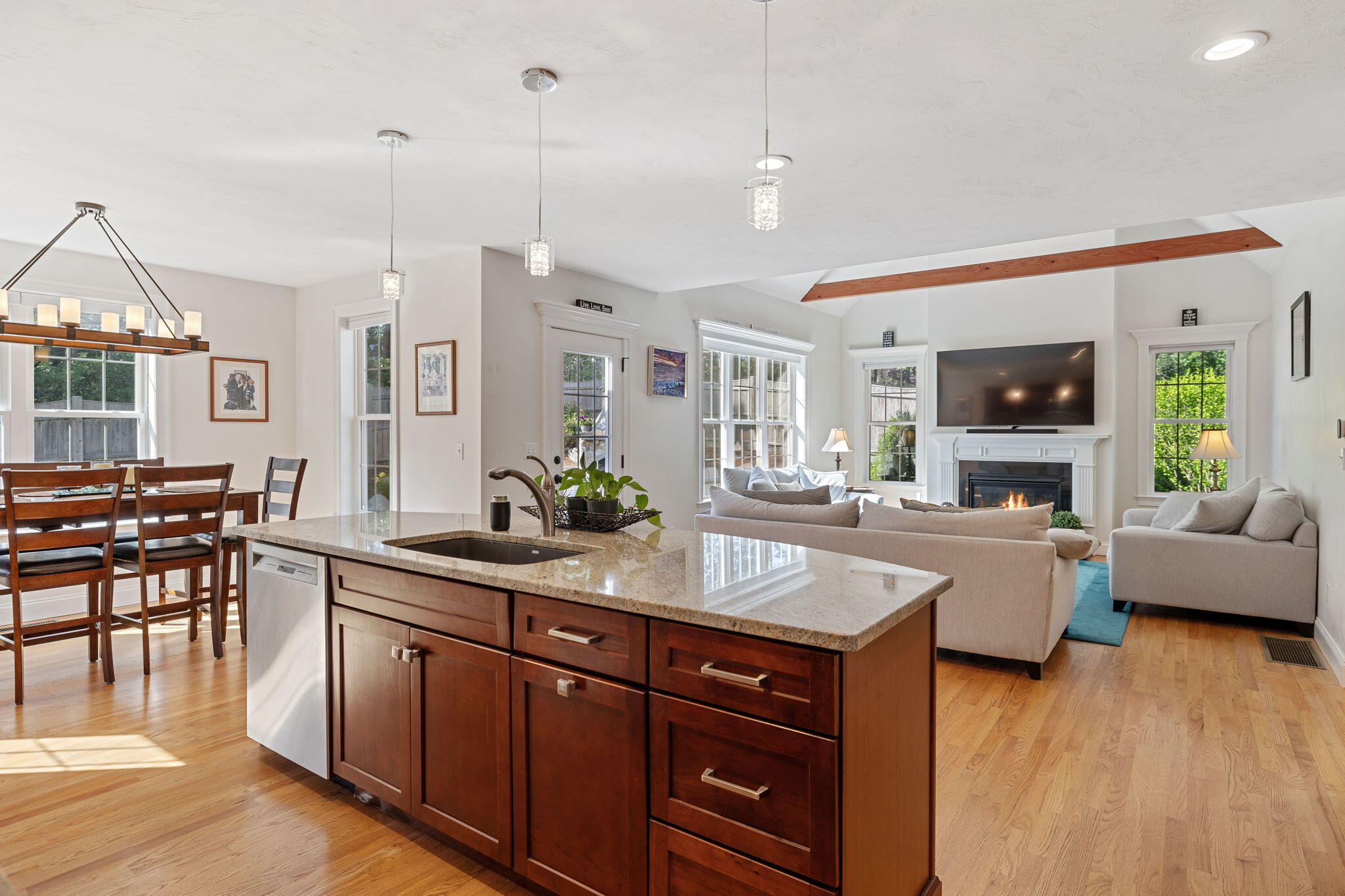 48 Meadowbrook Road Mashpee, MA 02649 - Photo 6 of 52 a living room with furniture a wooden floor and a fireplace