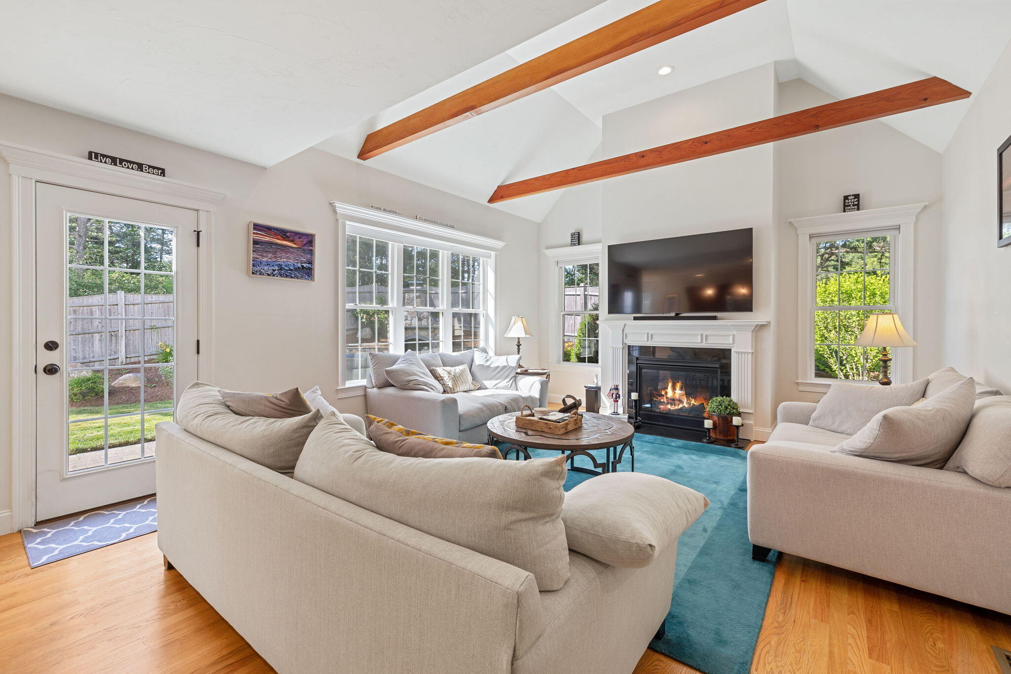 48 Meadowbrook Road Mashpee, MA 02649 - Photo 9 of 52 a living room with furniture a fireplace and a flat screen tv