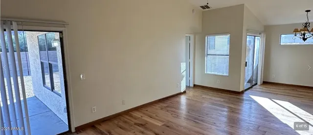 a view of a room with wooden floor and window