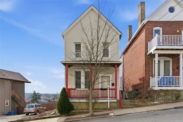a view of a brick house with large windows