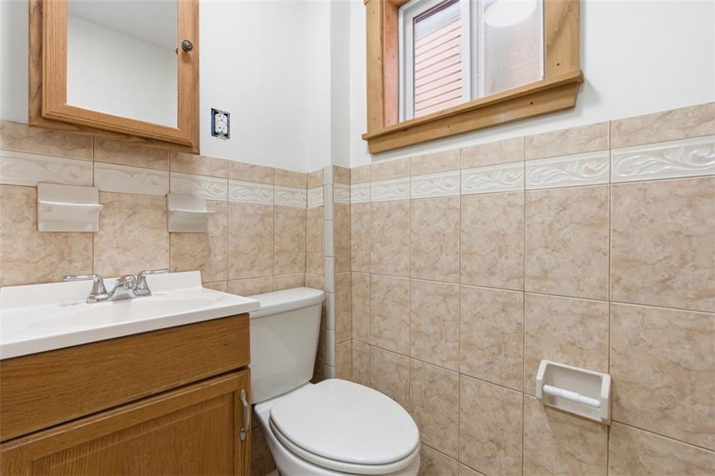 42 Cowan Street Pittsburgh, PA 15211 - Photo 12 of 27 a bathroom with a sink a toilet and a mirror