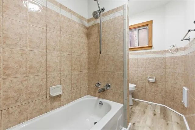 a bathroom with a bathtub and shower