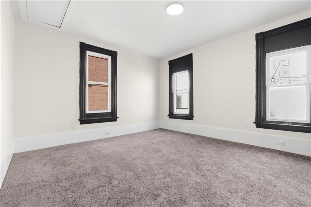 42 Cowan Street Pittsburgh, PA 15211 - Photo 18 of 27 an empty room with windows and closet