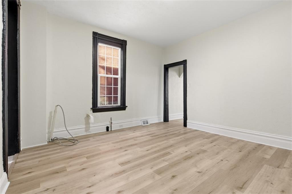 42 Cowan Street Pittsburgh, PA 15211 - Photo 19 of 27 a view of an empty room with window and mirror