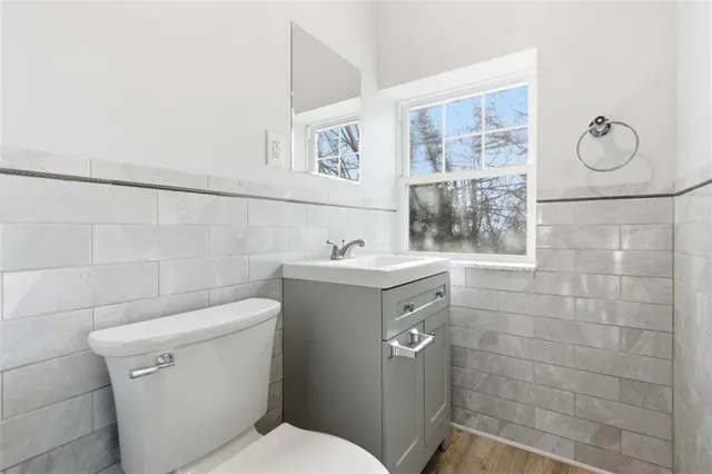 a bathroom with a sink mirror and toilet