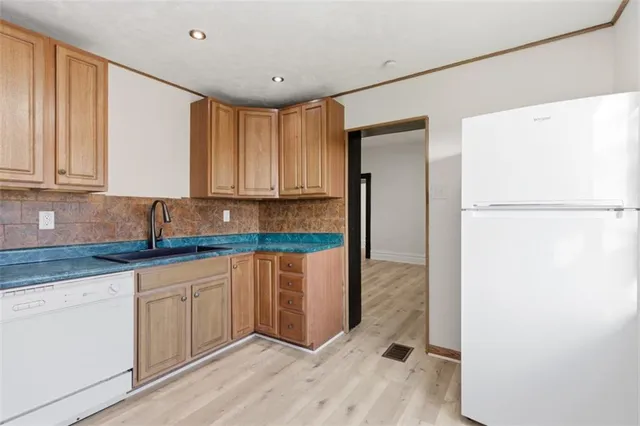a kitchen with a refrigerator and a sink