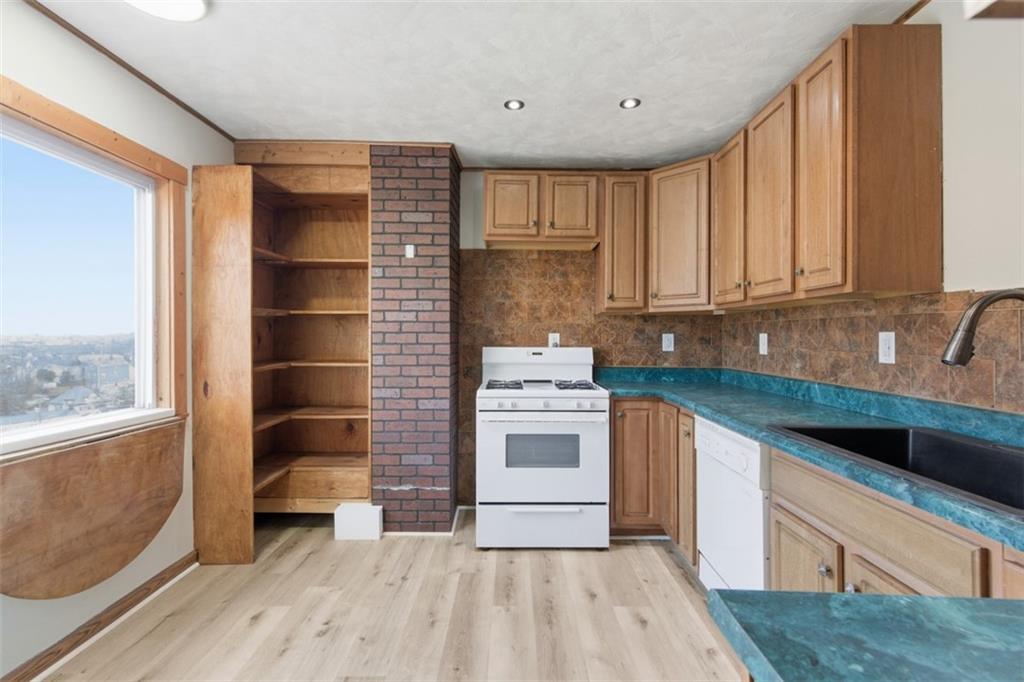 42 Cowan Street Pittsburgh, PA 15211 - Photo 7 of 27 a kitchen with stainless steel appliances granite countertop a stove a sink and a refrigerator