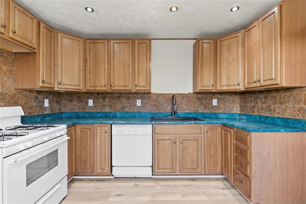42 Cowan Street Pittsburgh, PA 15211 - Photo 8 of 27 a kitchen with stainless steel appliances granite countertop a stove a sink and a white cabinets