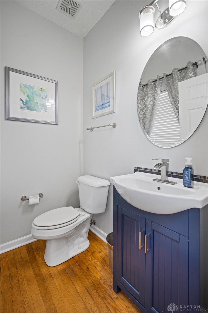 55 Janney Lane Springboro, OH 45066 - Photo 21 of 38 This cozy half bath features warm wood flooring, a sleek vanity, and modern fixtures.