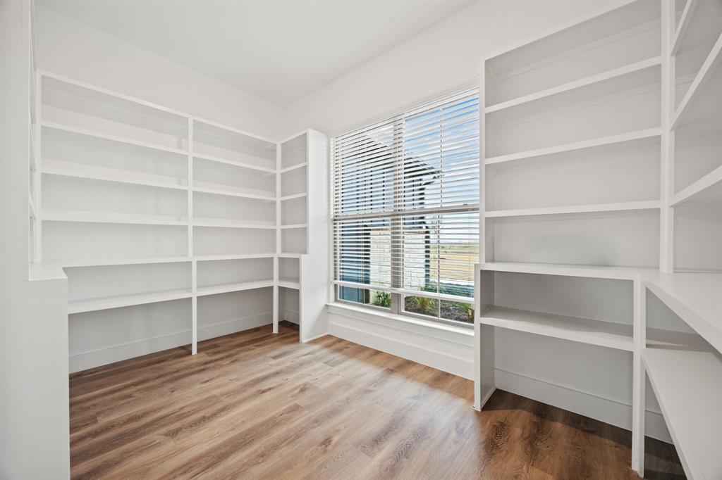 13721 Cash Mill Road Sanger, TX 76266 - Photo 13 of 28 a view of an empty room with a window and wooden floor