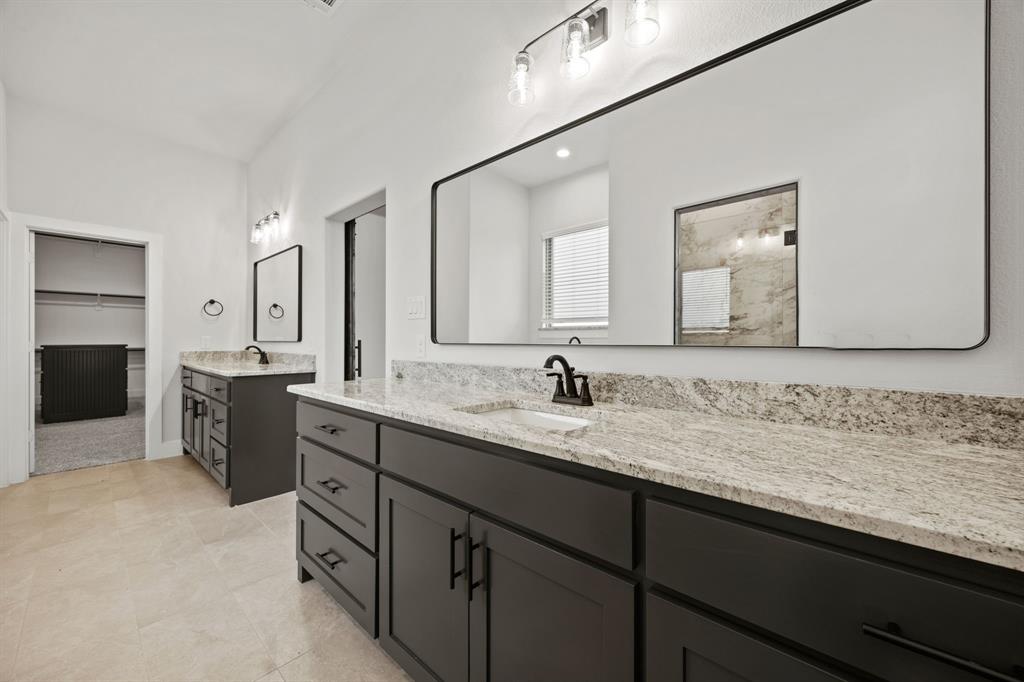 13721 Cash Mill Road Sanger, TX 76266 - Photo 19 of 28 a bathroom with a sink double vanity granite and a mirror