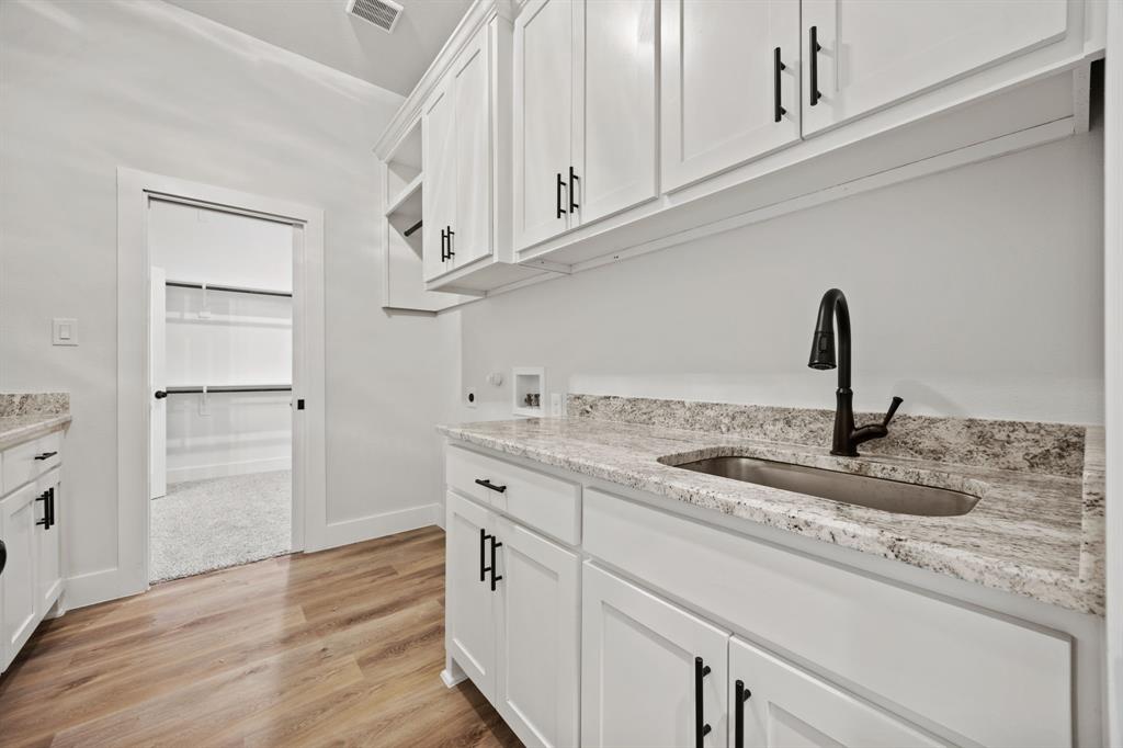 13721 Cash Mill Road Sanger, TX 76266 - Photo 24 of 28 a kitchen with appliances cabinets and a counter top space