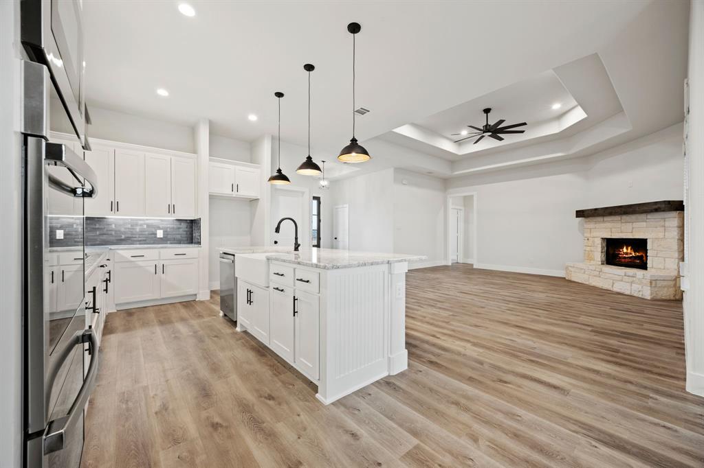 13721 Cash Mill Road Sanger, TX 76266 - Photo 28 of 28 a large white kitchen with a large window a sink and stainless steel appliances
