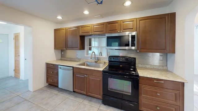 a kitchen with stainless steel appliances granite countertop a stove and a sink
