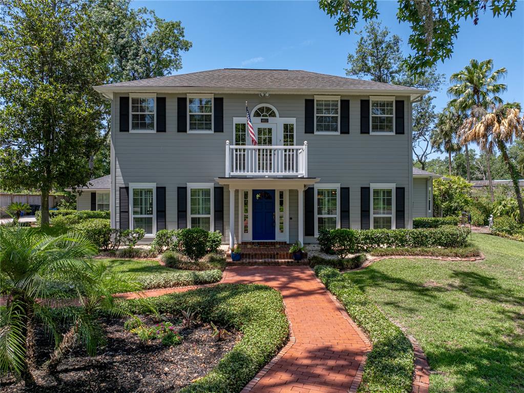 a front view of a house with yard and green space