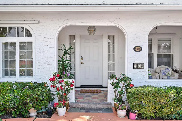 a front view of a house with flowers