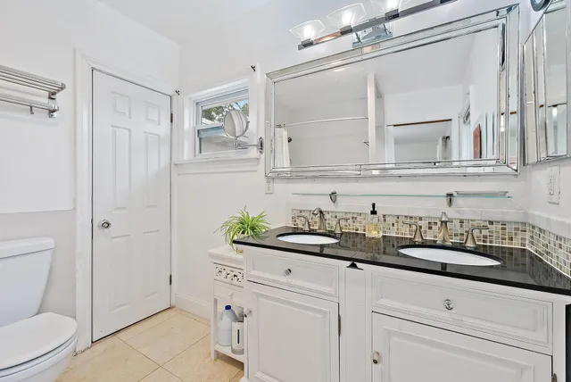 a bathroom with a sink a toilet and vanity