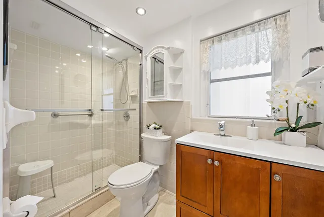 a bathroom with a sink toilet and shower