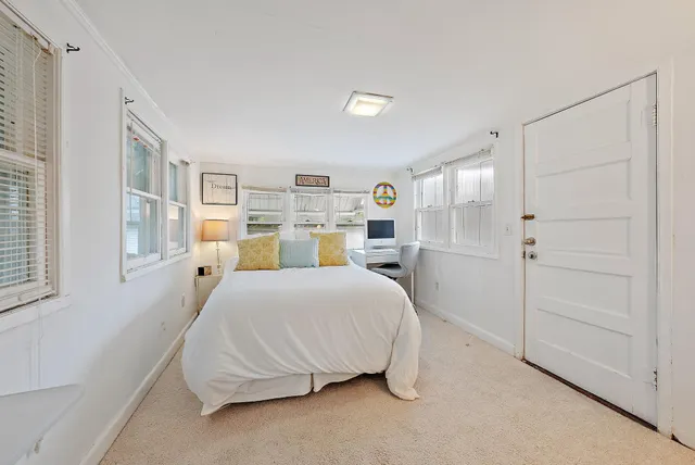 a spacious bedroom with a bed and a cabinets