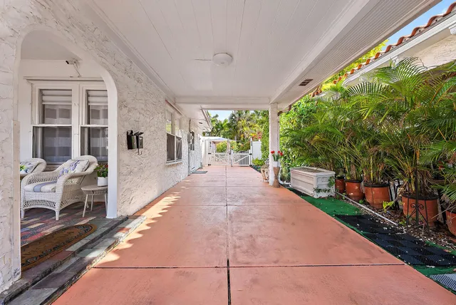 a view of a patio with table and chairs next to a yard
