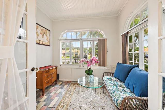 a living room with furniture and a potted plant