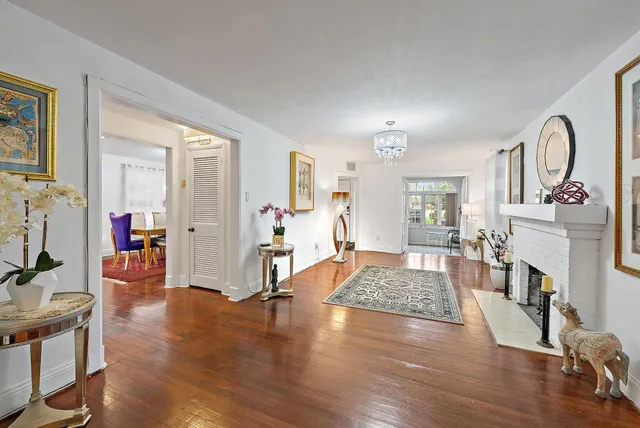 a living room with fireplace furniture and a wooden floor