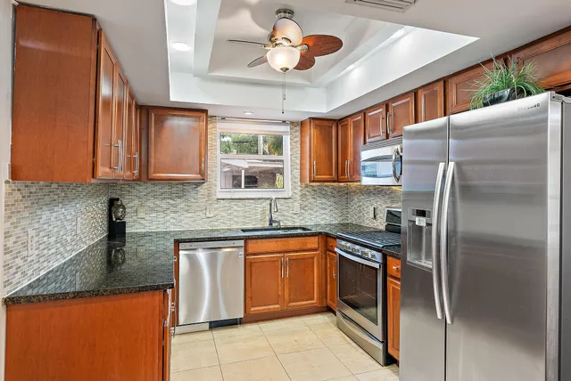 a kitchen with stainless steel appliances granite countertop a sink and cabinets
