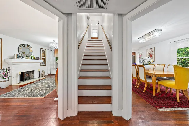 a view of entryway and hall with wooden floor