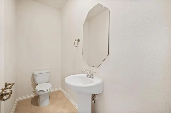 a bathroom with a toilet a sink and a mirror