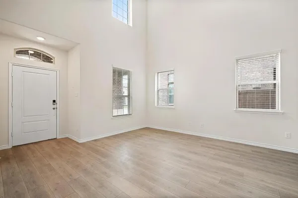 an empty room with windows and closet