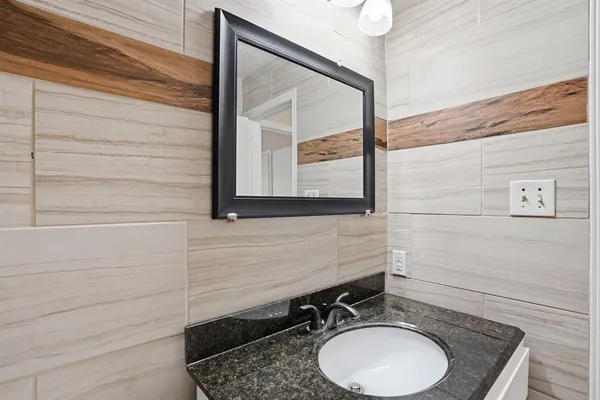 a bathroom with a sink a toilet and mirror