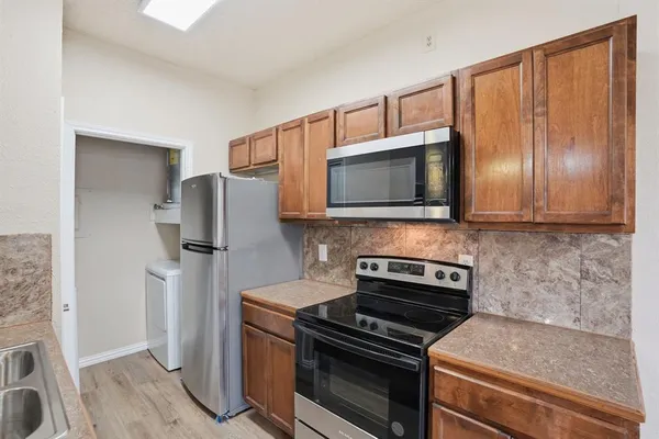 a kitchen with a refrigerator stove and microwave