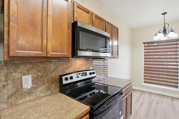 a kitchen with a stove and a microwave
