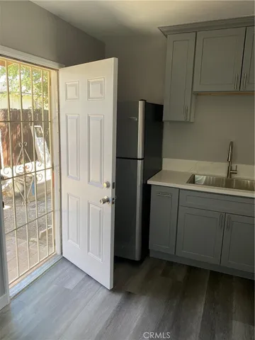 a kitchen with a refrigerator sink and cabinets
