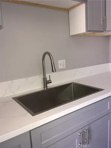 a close view of sink and cabinets