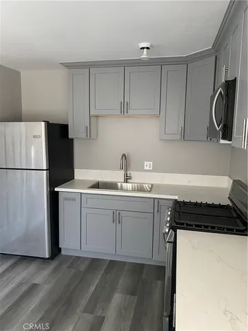a kitchen with a sink and a refrigerator