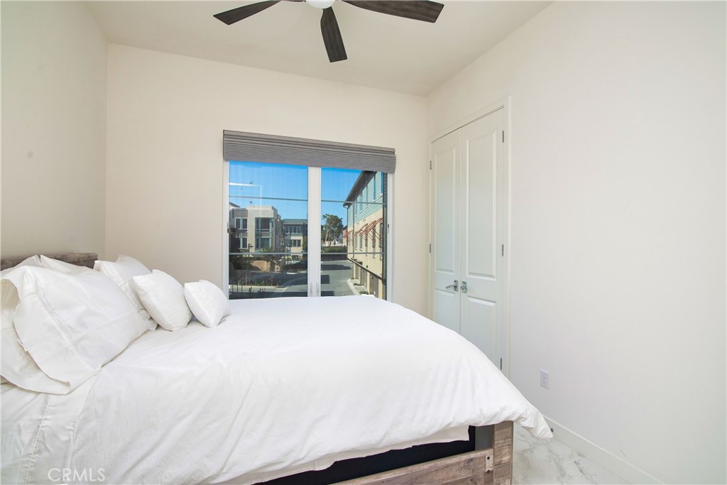 1523 Doheny Way Dana Point, CA 92629 - Photo 16 of 26 a bedroom with a bed and a large window