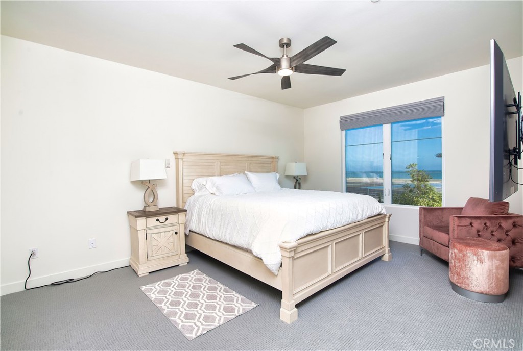 1523 Doheny Way Dana Point, CA 92629 - Photo 20 of 26 a bed sitting in a spacious bedroom next to a window