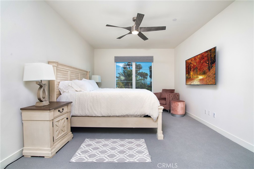 1523 Doheny Way Dana Point, CA 92629 - Photo 21 of 26 a bedroom with a bed and a painting on the wall