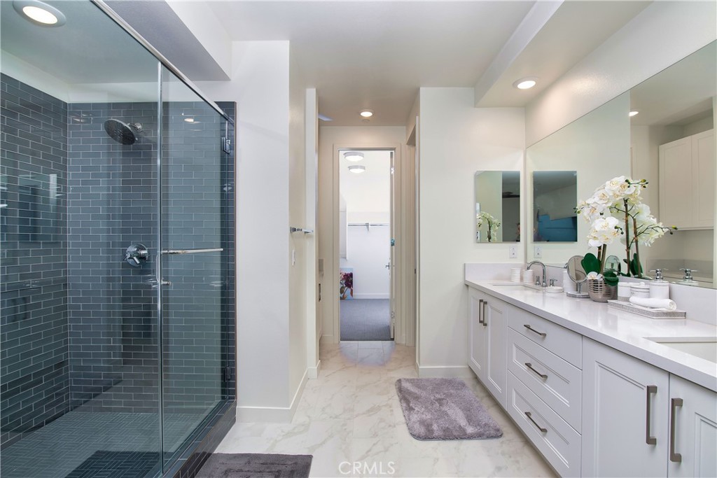 1523 Doheny Way Dana Point, CA 92629 - Photo 22 of 26 a bathroom with a double vanity sink toilet and shower