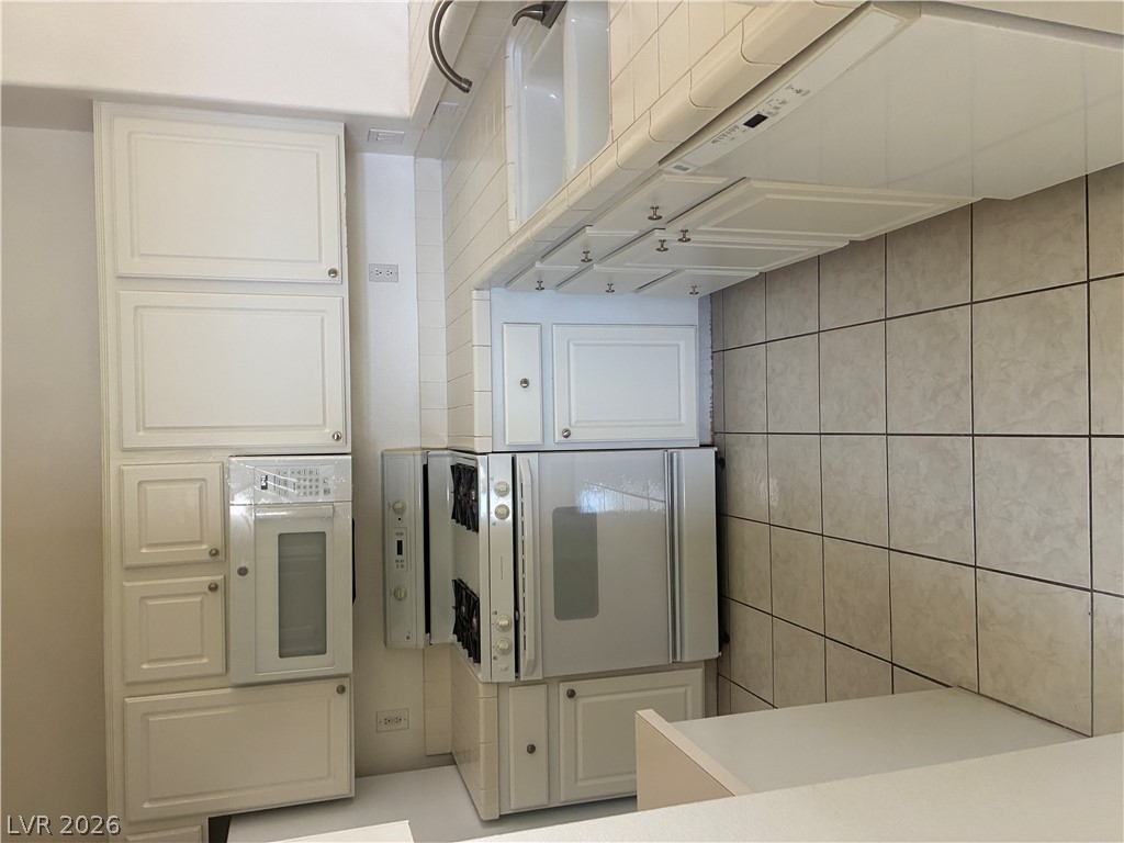 5272 Island Chain Road Las Vegas, NV 89118 - Photo 22 of 39 A streamlined kitchen layout features integrated appliances and clean-lined cabinetry.
