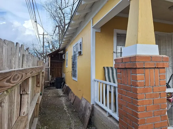 a view of a house with wooden fence