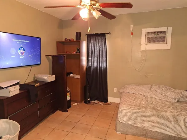 a bedroom with a bed and a chandelier