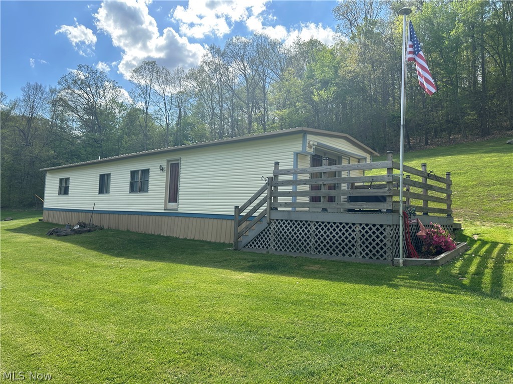 4041 Gray Road Kimbolton, OH 43749 - Photo 18 of 32 View of front facade with a wooden deck and a front lawn