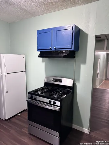 a kitchen with stainless steel appliances granite countertop a stove a refrigerator and a microwave