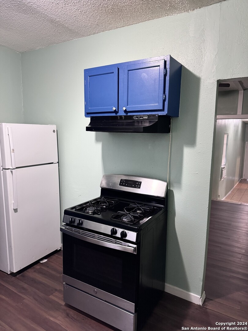 1902 Lennon Avenue, Unit 2 San Antonio, TX 78223 - Photo 7 of 16 a kitchen with stainless steel appliances granite countertop a stove a refrigerator and a microwave
