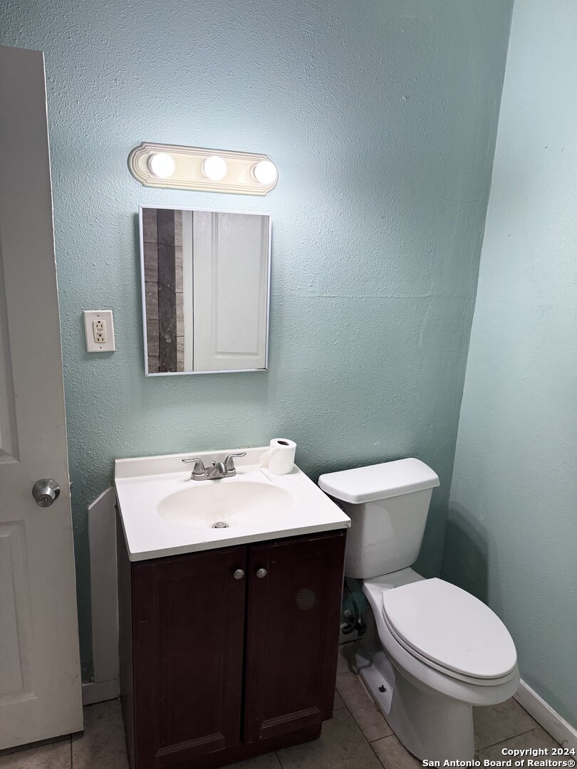 1902 Lennon Avenue, Unit 2 San Antonio, TX 78223 - Photo 8 of 16 a bathroom with a toilet sink and mirror