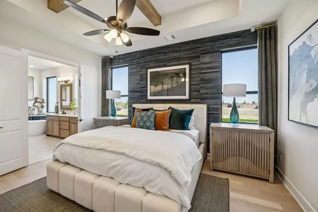 a spacious bedroom with a bed and a chandelier